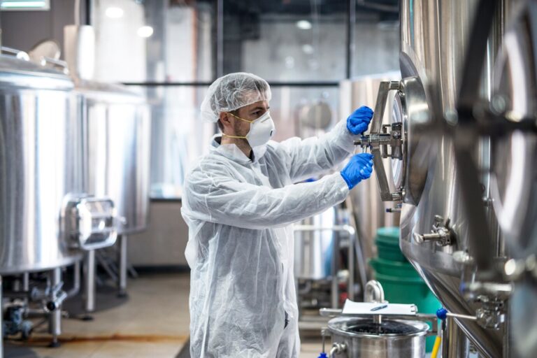 technologist-protective-uniform-wearing-hairnet-mask-goggles-gloves-closing-industrial-tank-reservoir_342744-1167 (1)